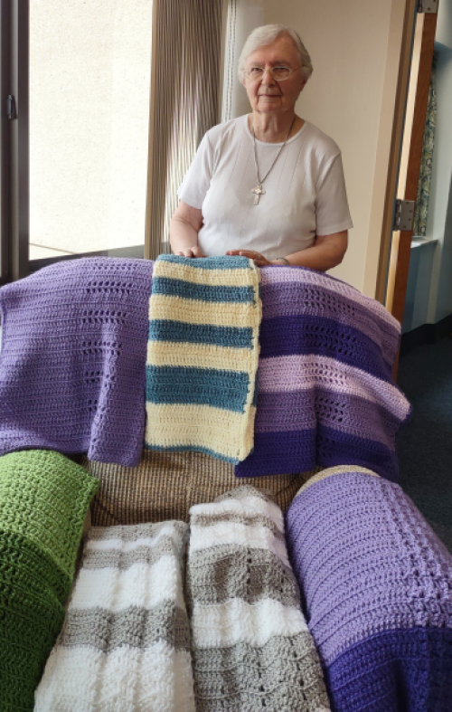 Sr. Dolorita and blankets she made